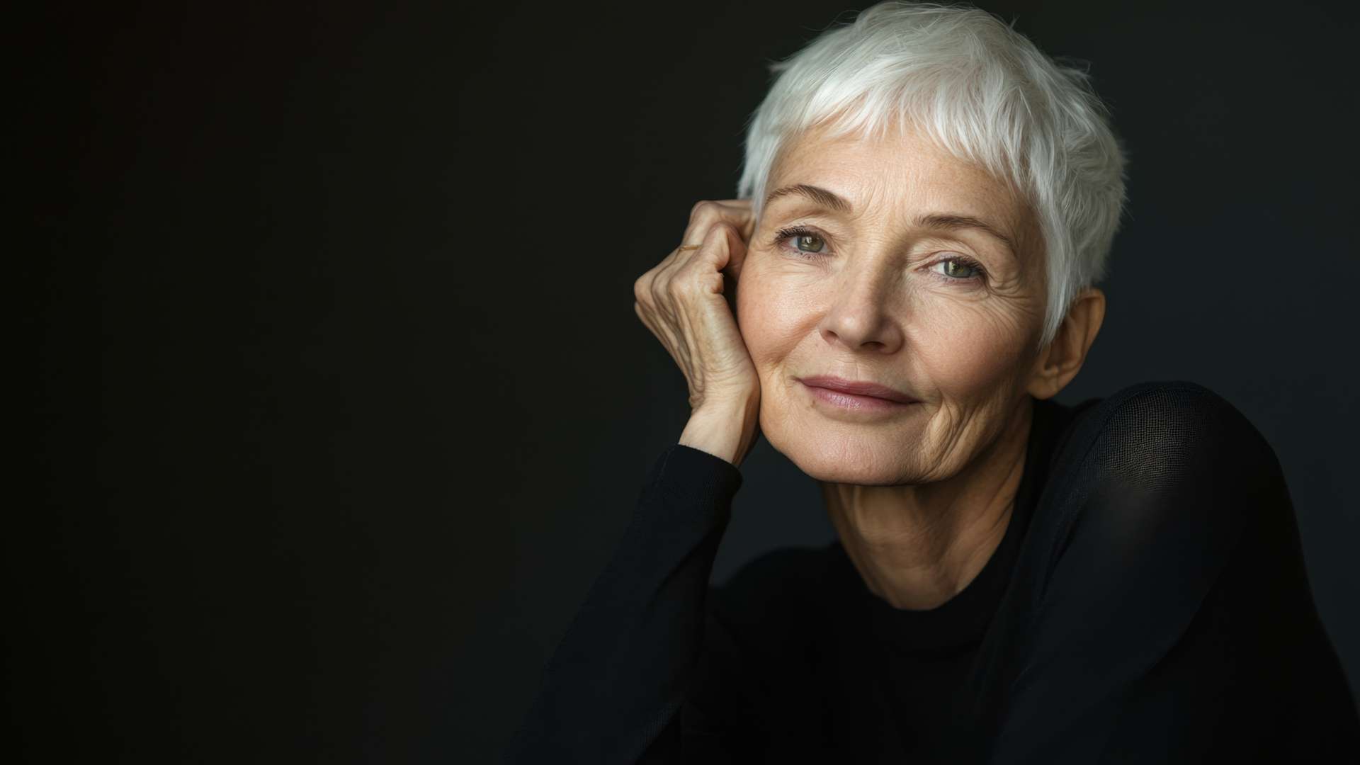 woman with short white hair on black background